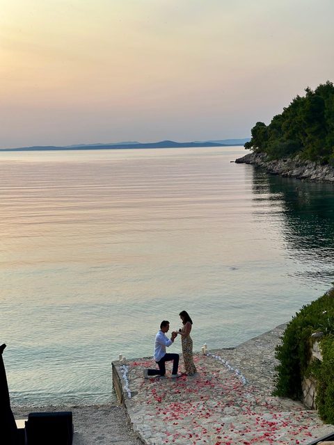 The proposal at the water's edge at sunset