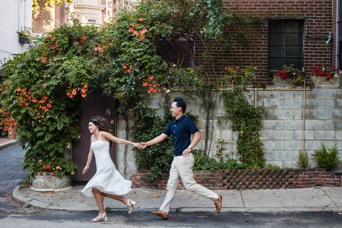 Running hand in hand past a wall of trumpet vine