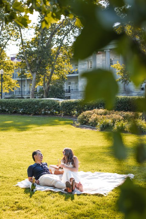 Laughing on a picnic blanket in the park