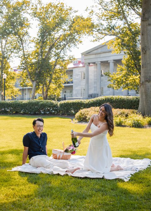 Opening champagne on the picnic blanket