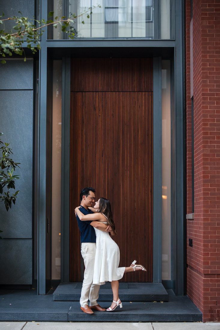 Taylor and Max kissing in a doorway, Taylor's heel kicked up